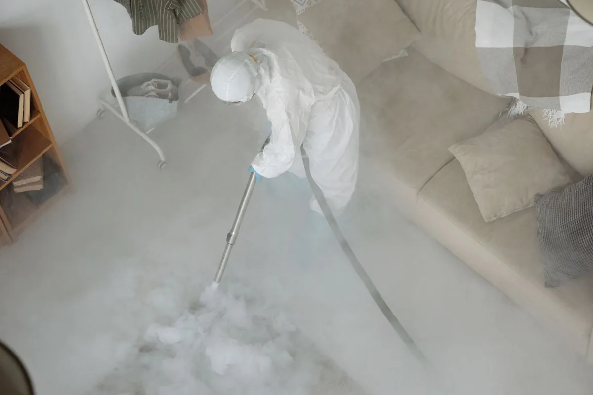 Biohazard cleanup technician in protective equipment, Purvis, MS